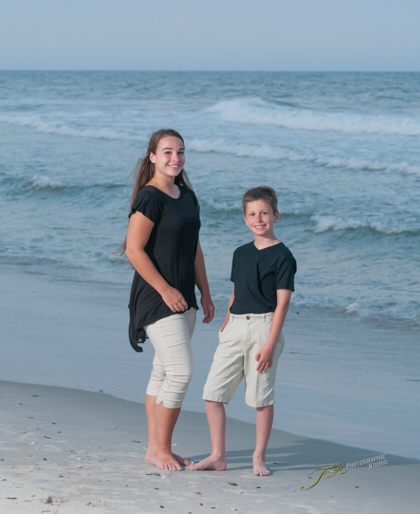 Happy Picture of 2 Siblings Posed at The Waters Edge on Topsail Island Beach