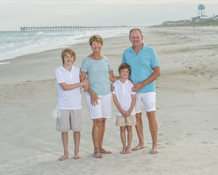 Family-Vacation-Portrait-of-Grandparents-With-Their-Grandsons-At-Topsail-Island-Beach-With-The-Peir-In-The-Background