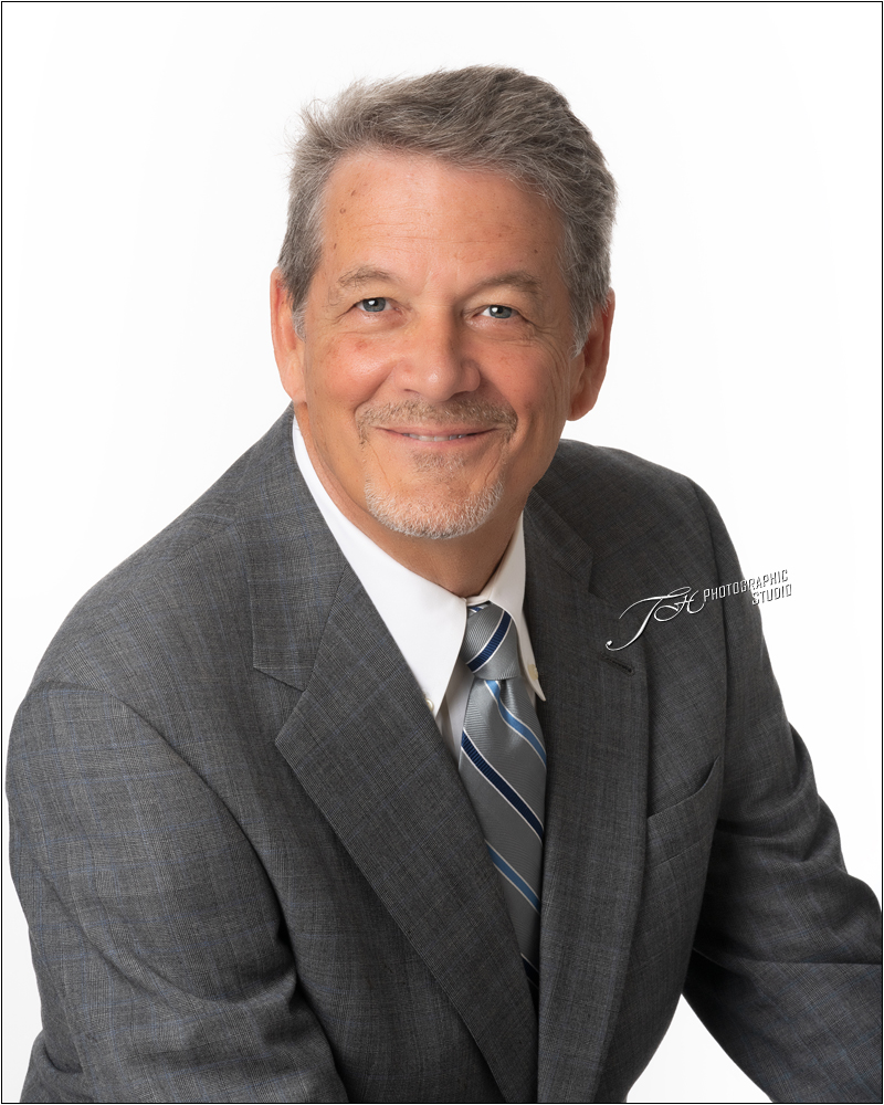Headshot-of-a-Kind-Business-Man-Photographed-In-Studio-On-A-White-Backgraound