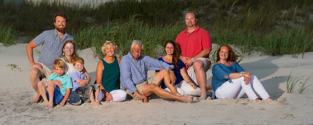 Portrait-Large-Family-Group-Sitting-in-Front-Of-The-Dunes-at-Serenity-Point-NC