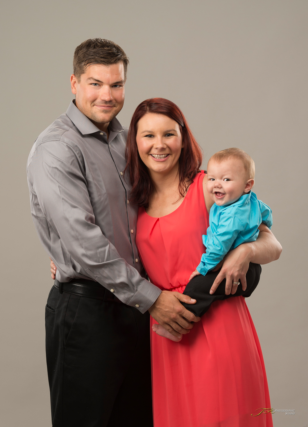 Portrait-of-a-Mom-Dad-and-Baby-Dressed-Up-In-Studio-